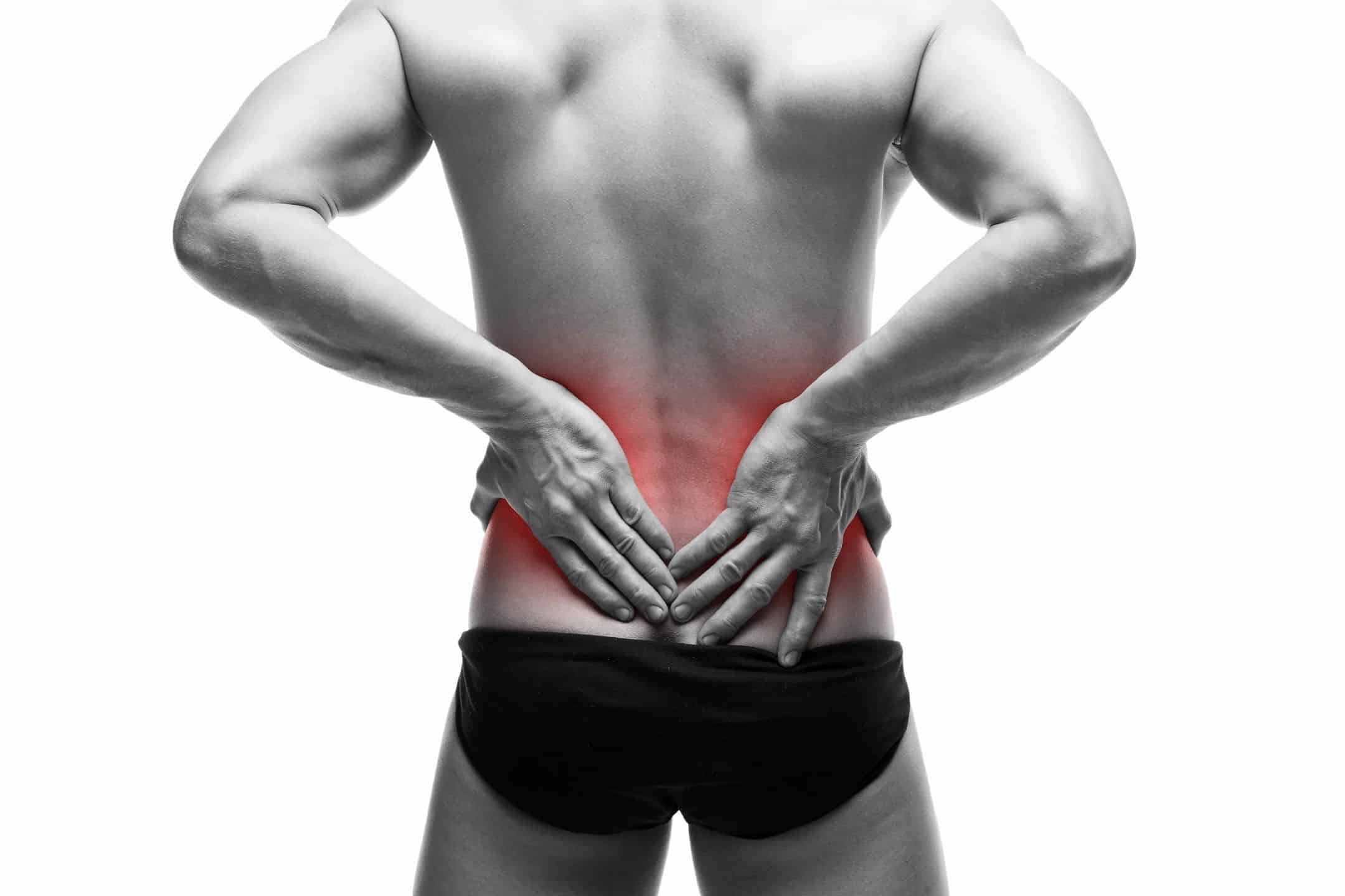 a man with his back to the camera puts his hands on a stylized red region of his lower back indicating he is in pain in that area