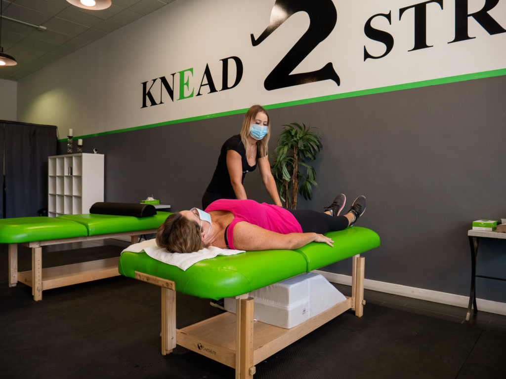 K2S employees demonstrating stretching techniques while wearing facemasks